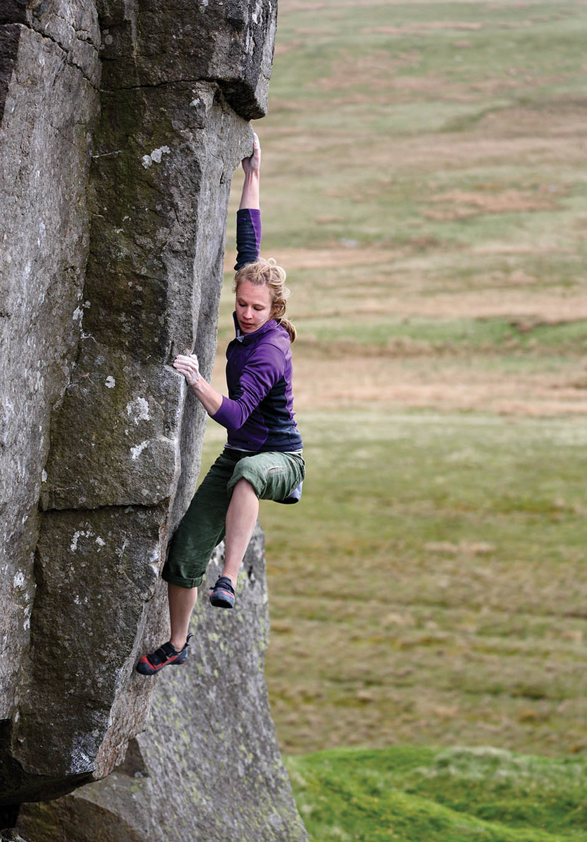 The twin arêtes of Old Moss give an absorbing problem of the highest quality; Charlotte Telfer boulders out this Font 5+. Photo: David Simmonite